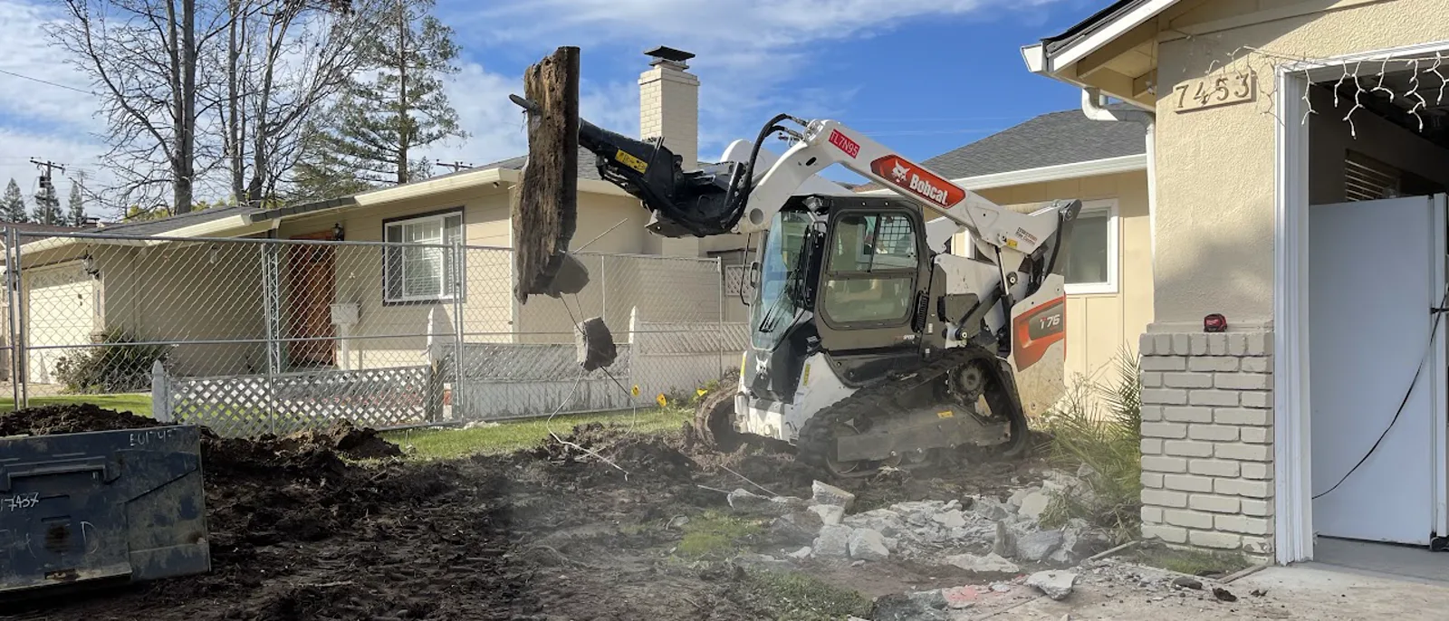 Construction site demolition beside a home